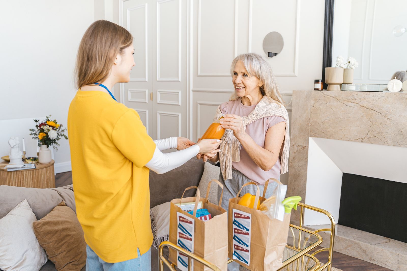 A caregiver visiting an older woman at home
